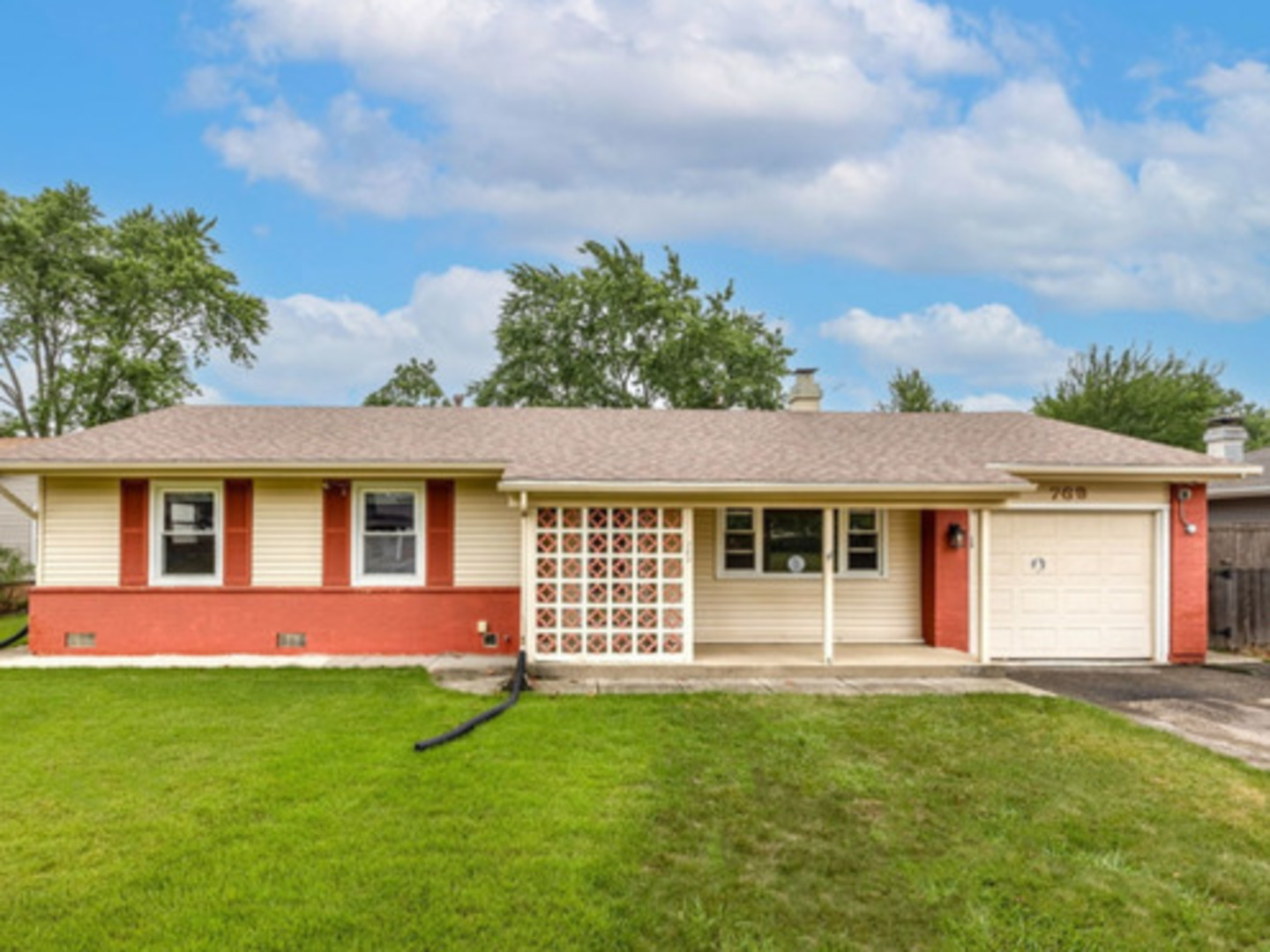 769 Penrith Avenue Elk Grove Village, IL 60007 - Photo 1 of 10 a front view of a house with a garden