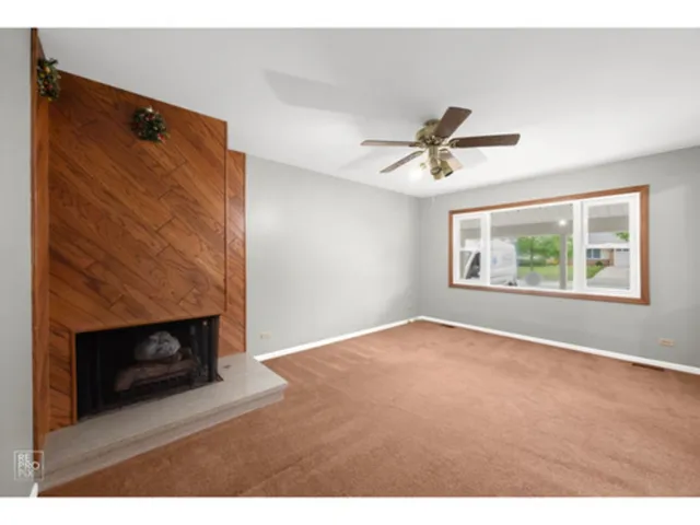 a view of an empty room with a fireplace