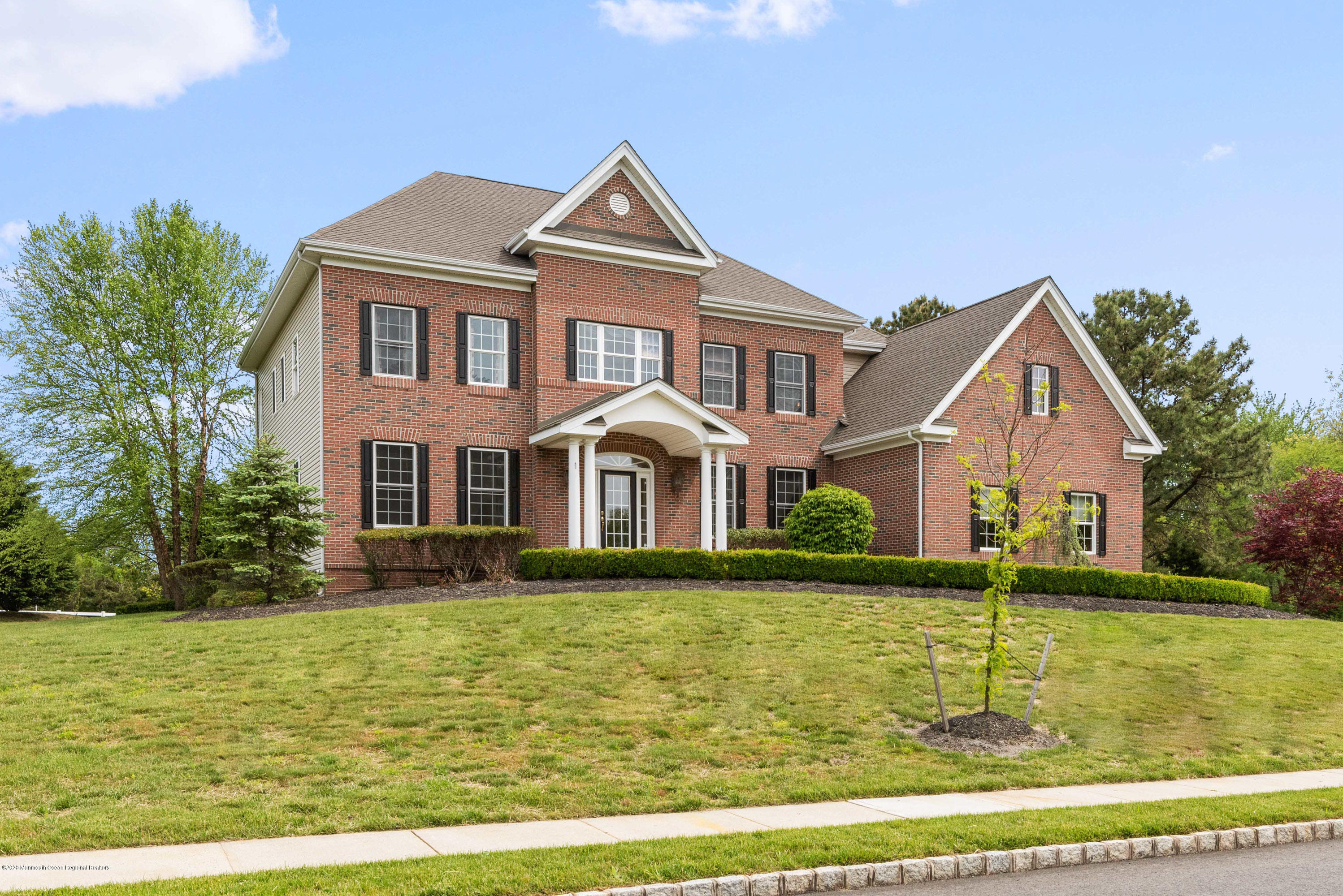 a front view of a house with a yard