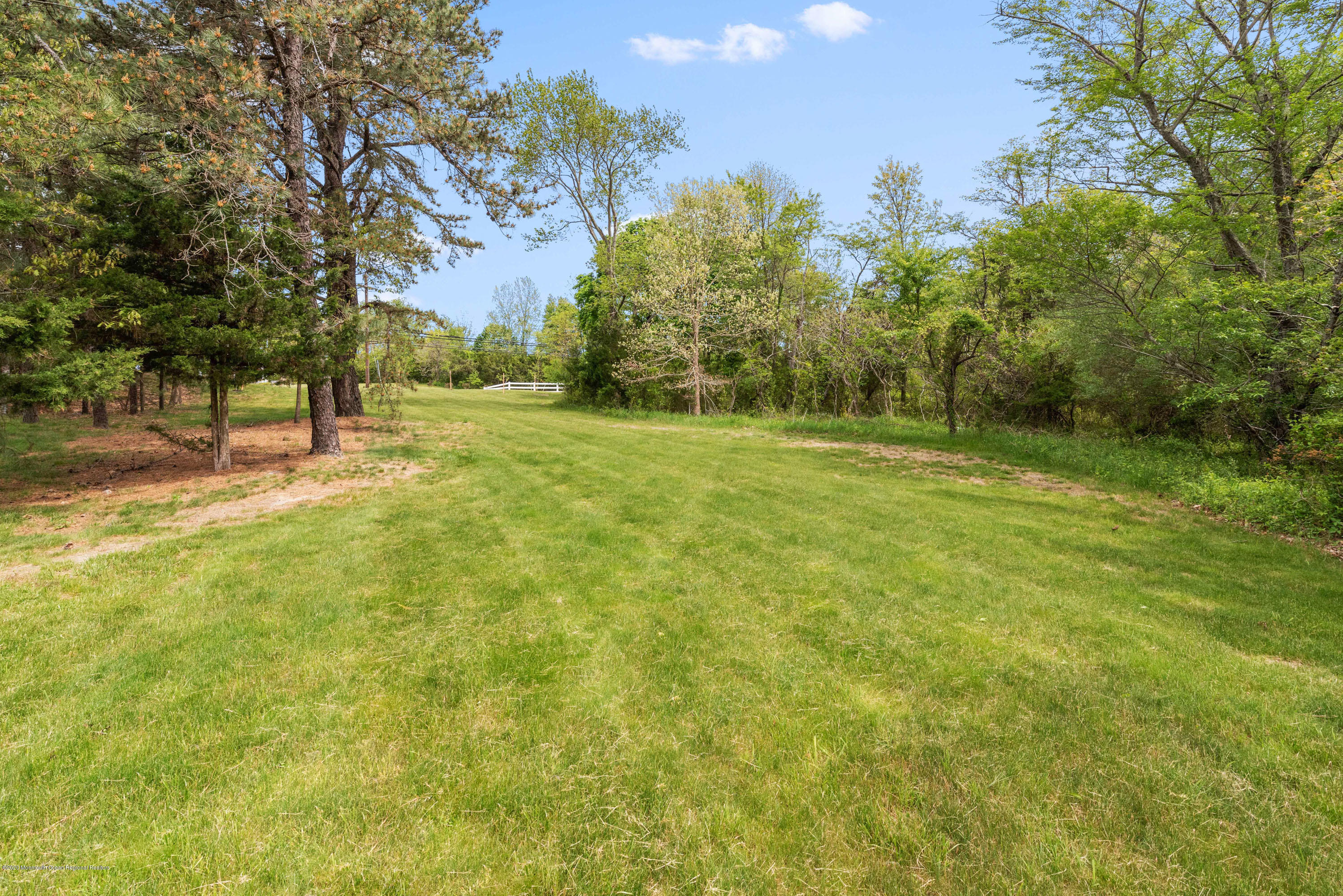 1 Bellagio Road Jackson, NJ 08527 - Photo 39 of 48 a view of a field with trees in the background