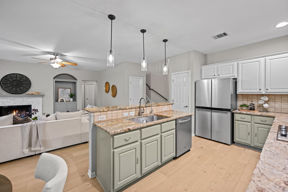 2823 Lantana Ridge Drive Austin, TX 78732 - Photo 10 of 34 a kitchen with a sink stove and refrigerator