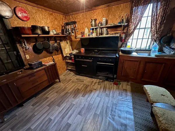 a living room with lots of furniture and kitchen view
