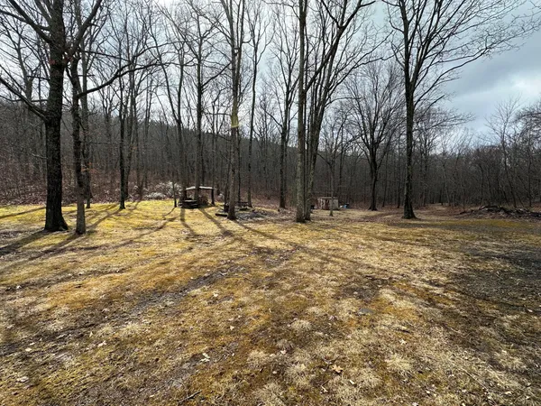 a backyard of a house with table and chairs