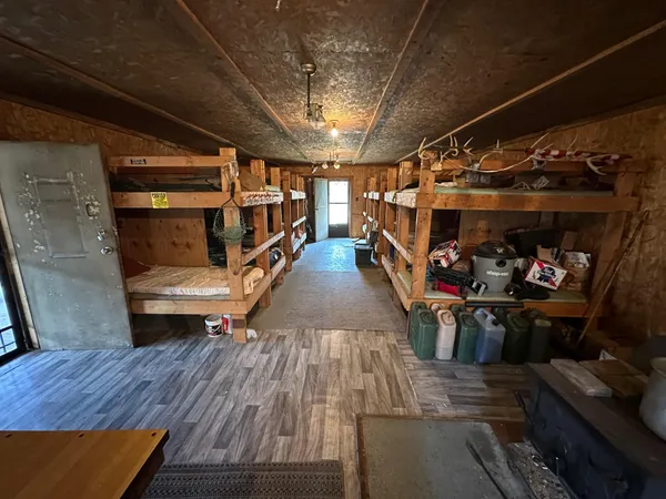 a room with wooden floors and flat screen tv