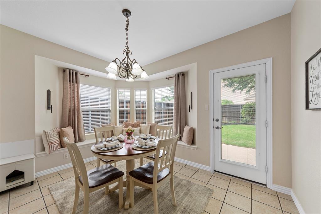 Dining space featuring baseboards, a notable chandelier, and light tile patterned floors