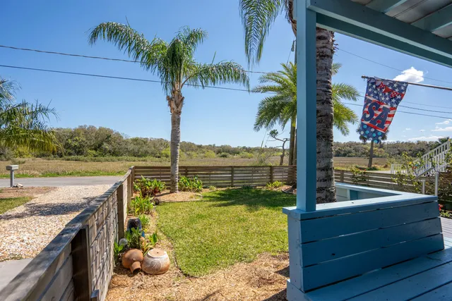 a view of a backyard with wooden fence