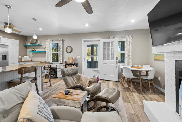 a living room with furniture a fireplace and a flat screen tv