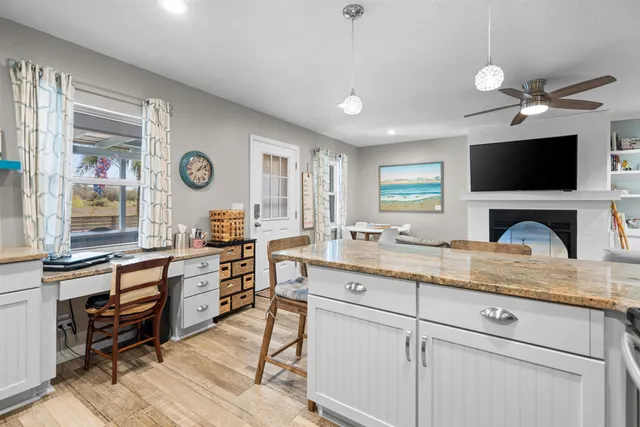 a kitchen with stainless steel appliances granite countertop a refrigerator and a stove top oven
