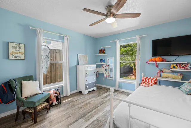 a bedroom with a bed and a large window