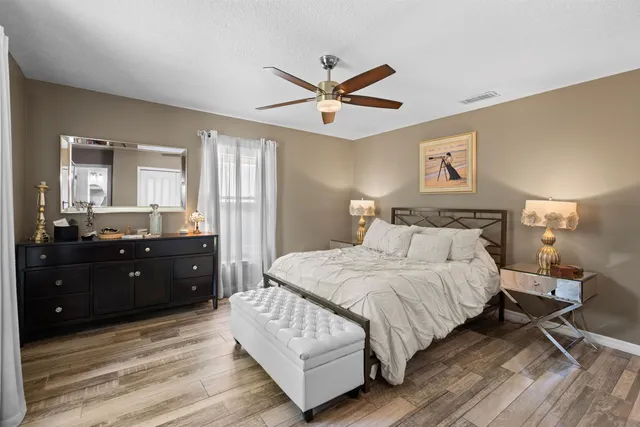 a bedroom with a bed and a large mirror