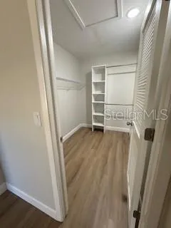 a view of walk in closet with empty racks