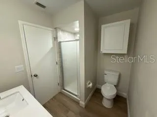 a bathroom with a toilet and a shower