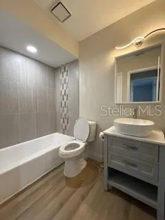 a bathroom with a sink a toilet and bathtub