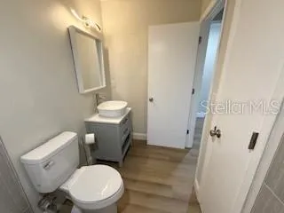 a white toilet sitting next to a bathroom sink