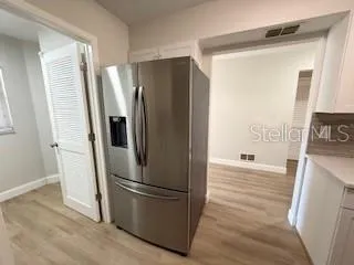 a metallic refrigerator freezer sitting in a kitchen
