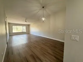 a view of a room with wooden floor and window
