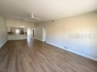 a view of empty room with wooden floor
