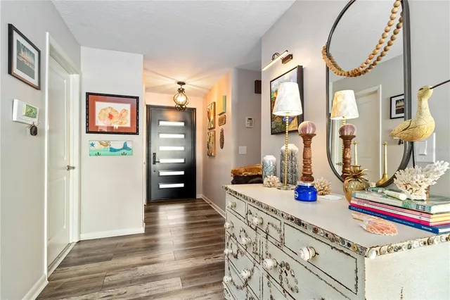 a view of living room with furniture and wooden floor