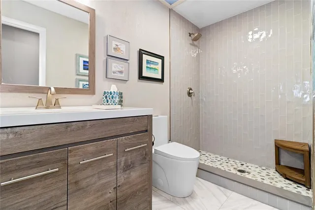 a bathroom with a sink a toilet and mirror