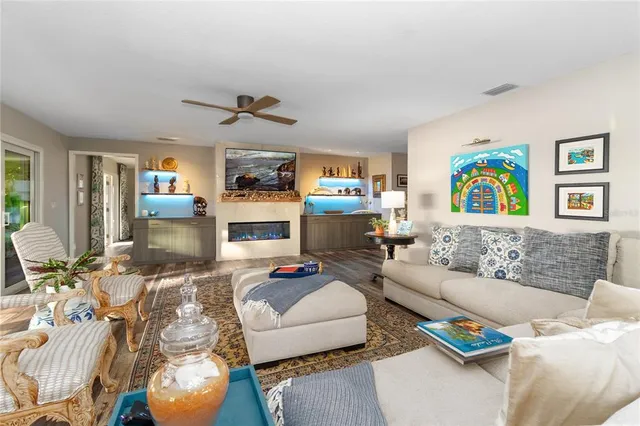 a living room with furniture kitchen view and a fireplace