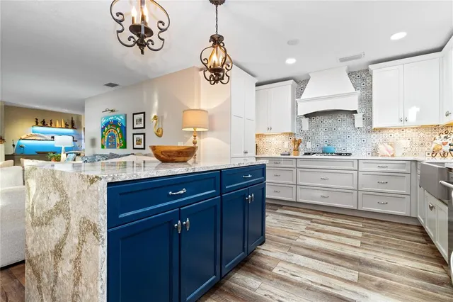 a kitchen with a sink dishwasher a stove and a microwave oven