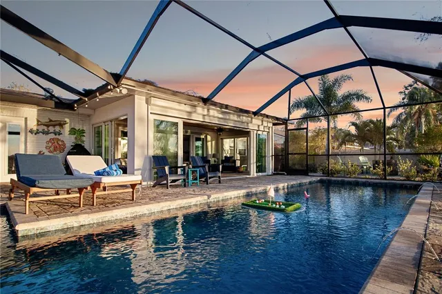 a swimming pool with outdoor seating and yard