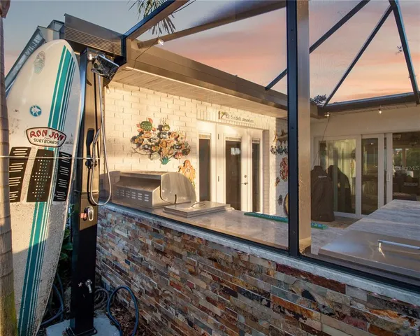 a view of a porch with wooden floor and furniture
