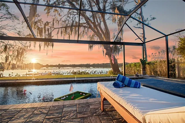 a view of swimming pool with a patio and a yard