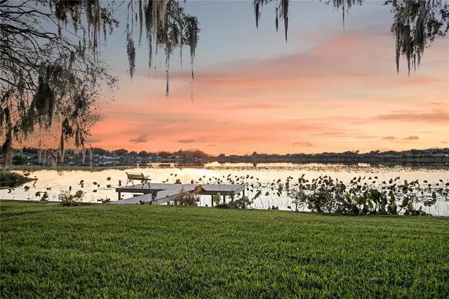 a view of a lake with houses in the back