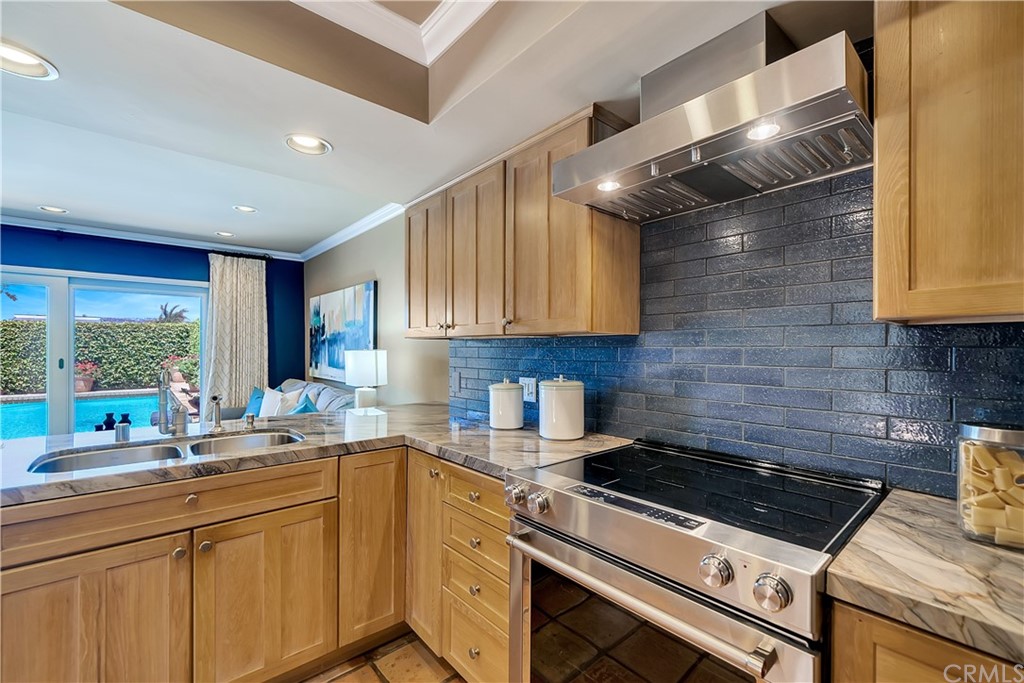 23802 Cassandra Bay Dana Point, CA 92629 - Photo 21 of 48 a kitchen with a stove a sink and a cabinets