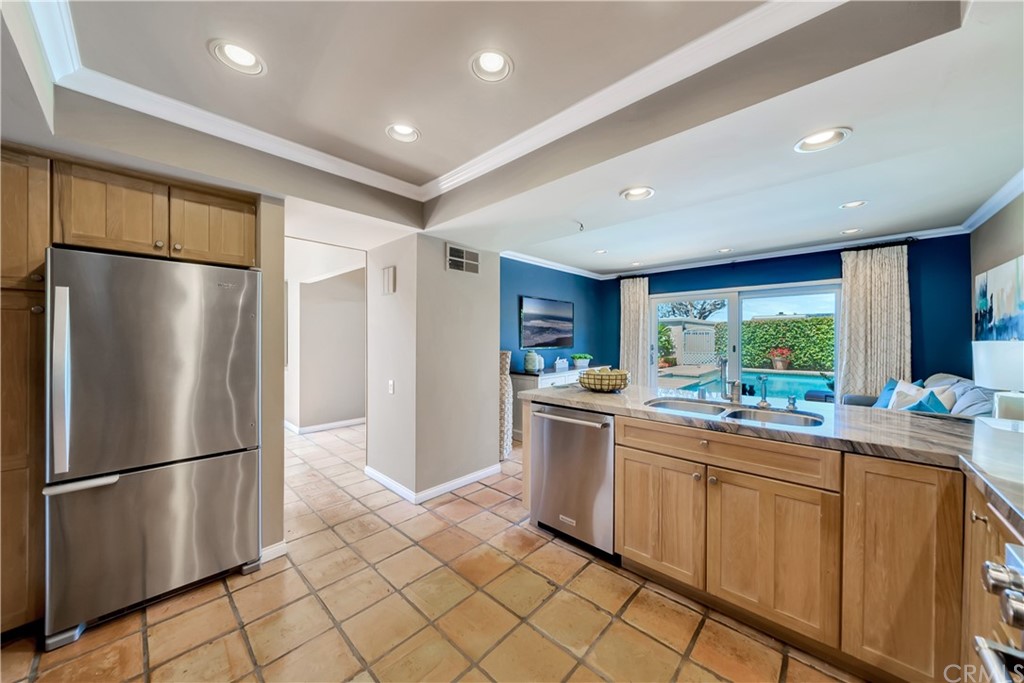 23802 Cassandra Bay Dana Point, CA 92629 - Photo 23 of 48 a kitchen with a refrigerator and a sink