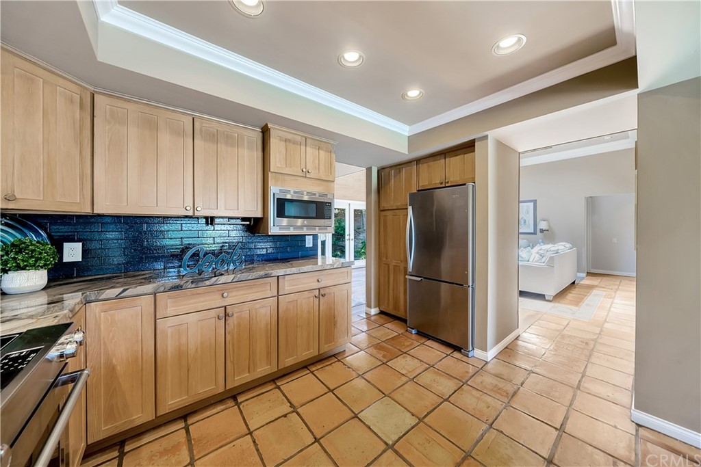 23802 Cassandra Bay Dana Point, CA 92629 - Photo 30 of 48 a kitchen with stainless steel appliances granite countertop a refrigerator and a sink