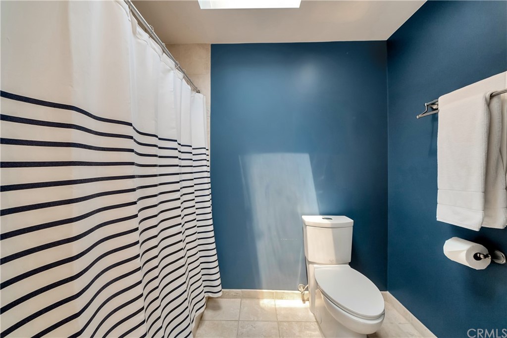 23802 Cassandra Bay Dana Point, CA 92629 - Photo 35 of 48 a white toilet sitting next to a shower curtain