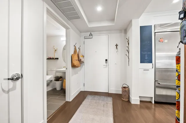 a view of walk in closet with wooden floor