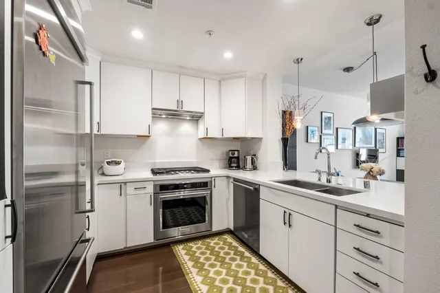a kitchen with a sink stove and refrigerator