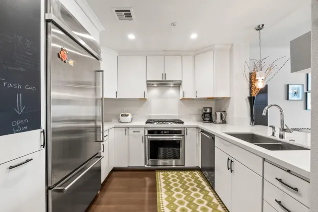 a kitchen with a refrigerator sink and stove