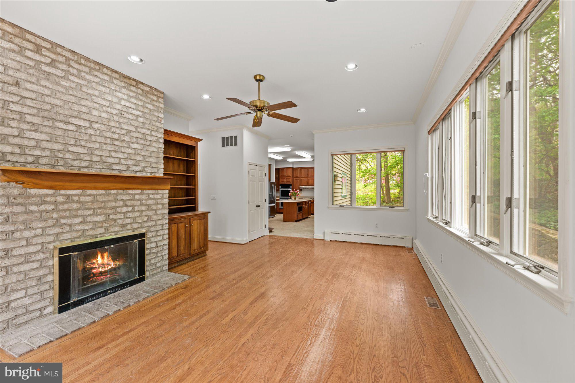 6013 Selvyn Road Bethesda, MD 20817 - Photo 12 of 54 Family room with fireplace and built-in cabinets