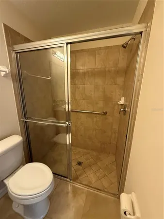 an empty room with a chandelier fan