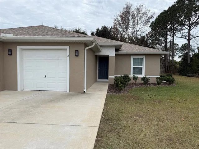 a view of a house with a backyard