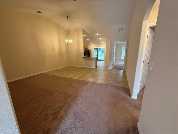 a view of a hallway with a kitchen