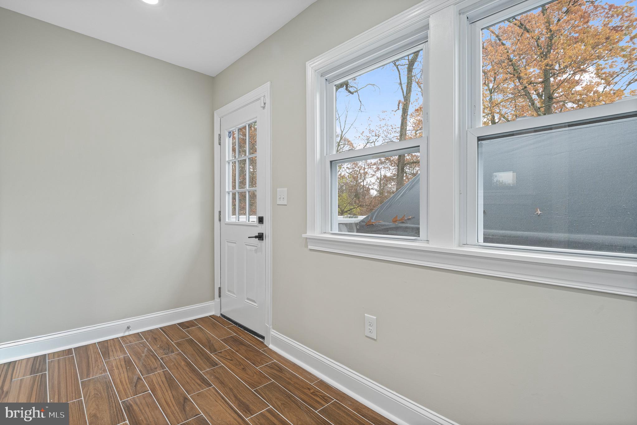 9217 Fowler Lane Lanham, MD 20706 - Photo 43 of 80 an empty room with wooden floor and windows