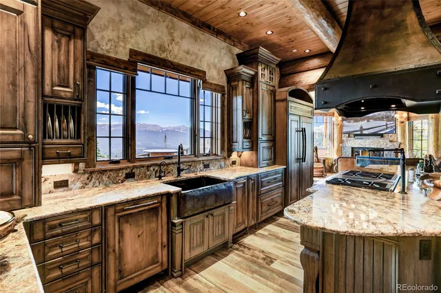 a living room with fireplace furniture and a large window