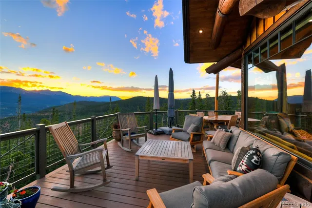 a living room with fireplace furniture and a large window