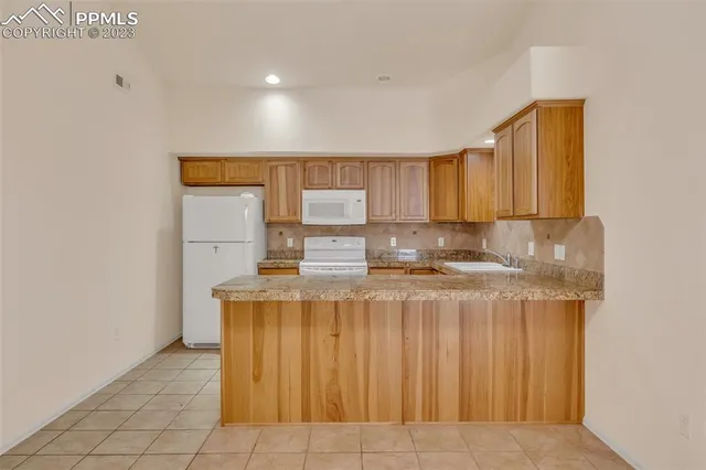 a kitchen with stainless steel appliances a sink stove and cabinets