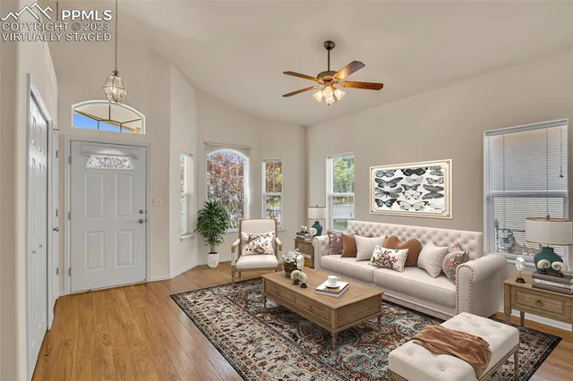 a living room with furniture and a chandelier