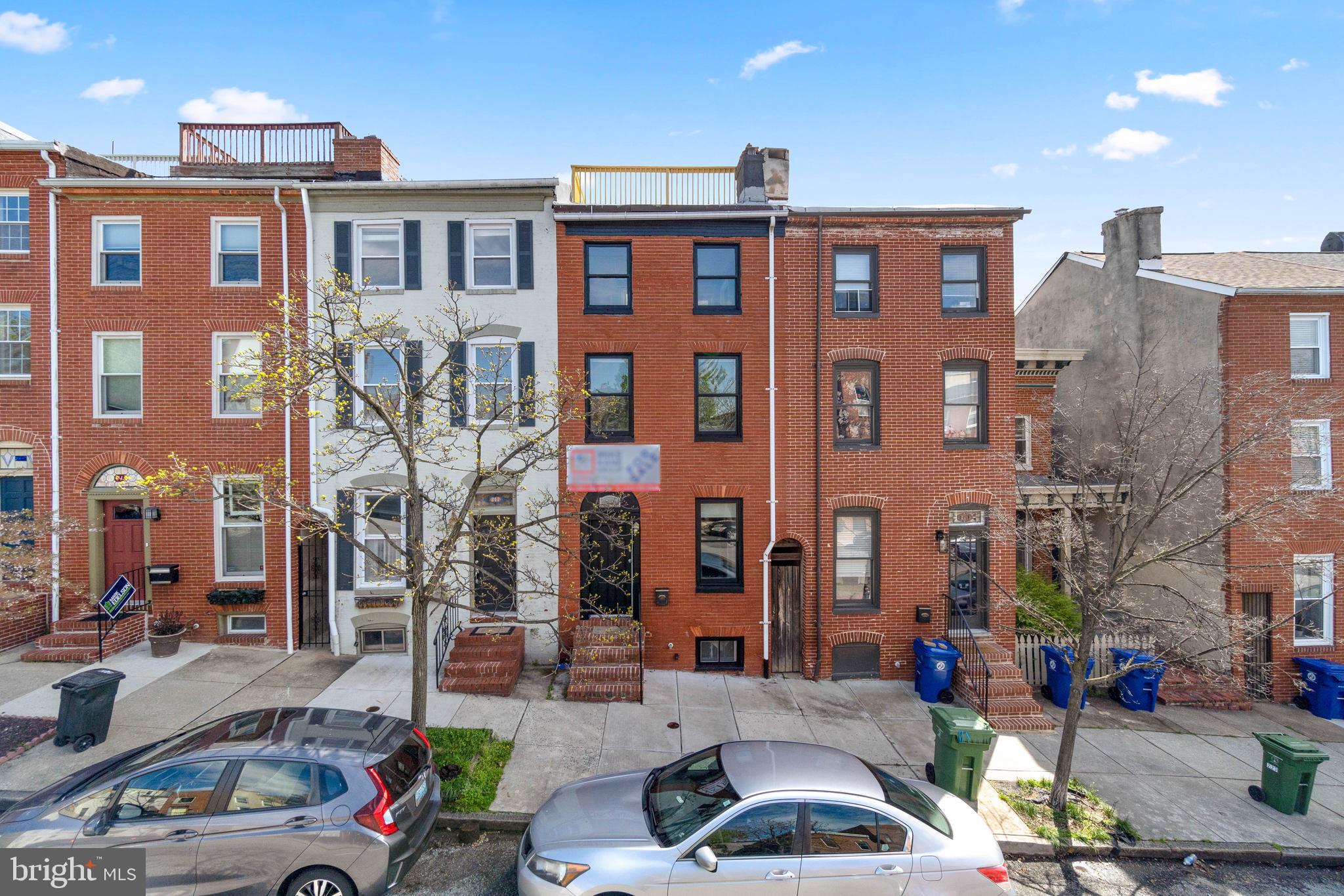 219 South Washington Street Baltimore, MD 21231 - Photo 3 of 5 a front view of a building with parking