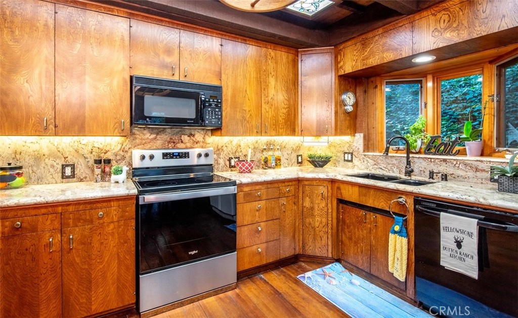3001 Edmonton Road Glendale, CA 91206 - Photo 17 of 75 a kitchen with stainless steel appliances wooden cabinets and a stove top oven