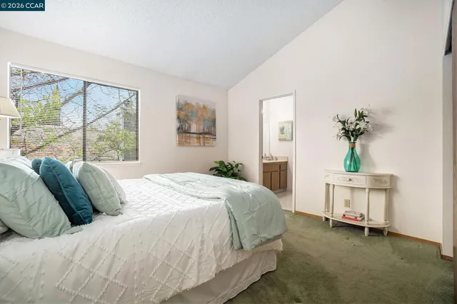 a bedroom with a bed and a potted plant
