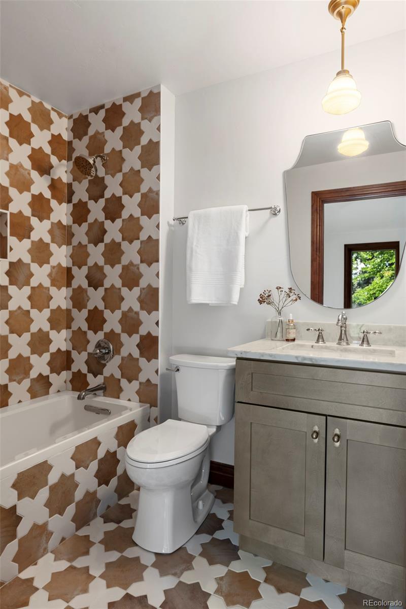 1026 South Cook Street Denver, CO 80209 - Photo 23 of 34 a bathroom with a sink toilet and shower