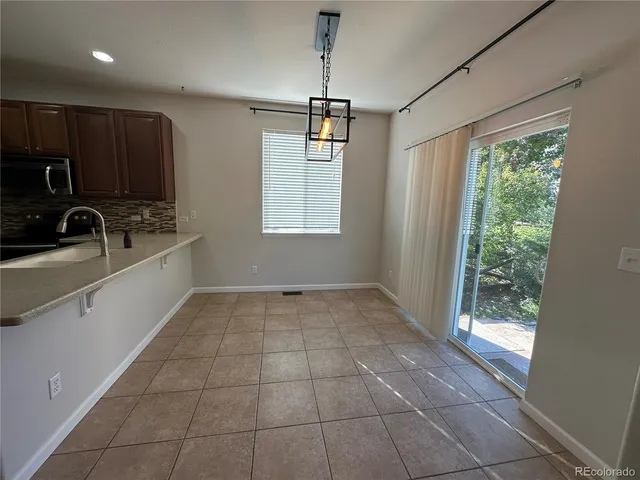 a view of a kitchen with a sink and cabinets